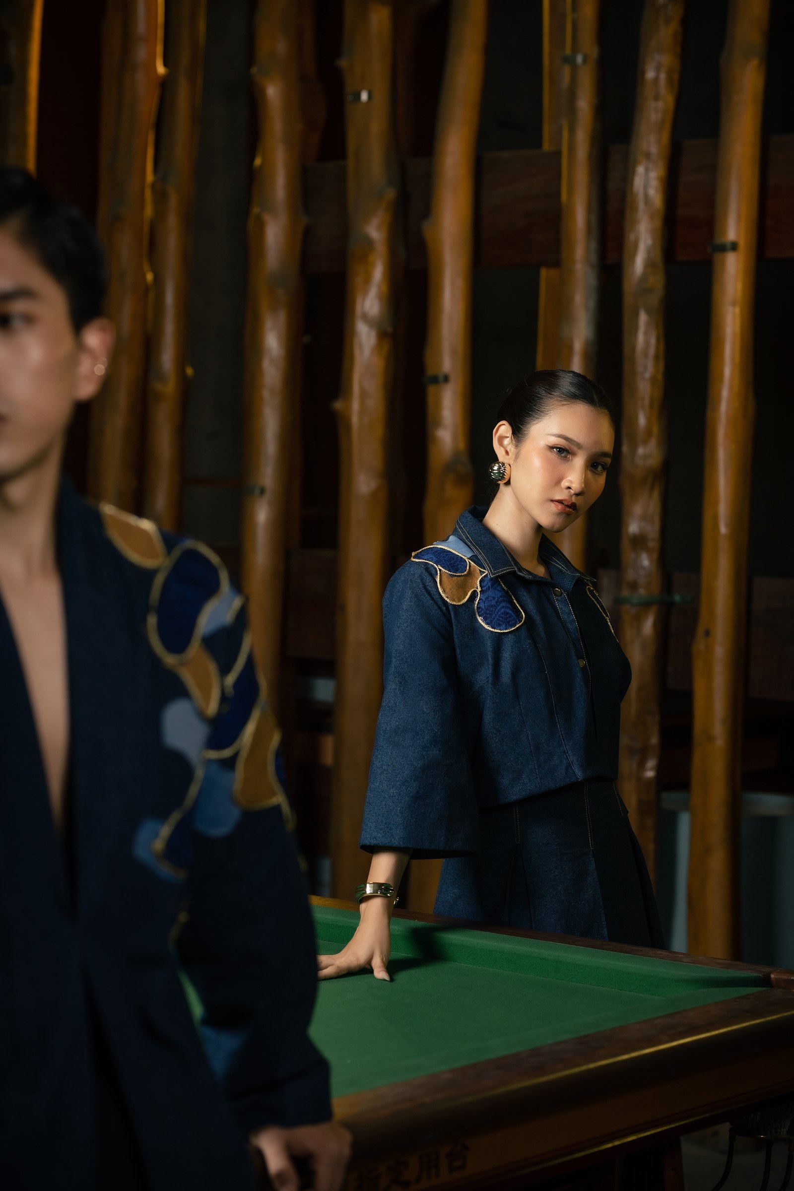 Two models in indigo denim from Myanmar's Essence, at a pool table